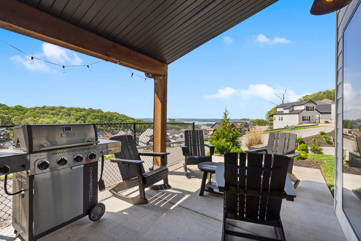 This exterior image features a grill and adjoining seating area set against a scenic landscape, suggesting the enjoyment of outdoor dining and group gatherings. The relaxed atmosphere and inviting setup evoke memories of shared meals and celebrations, reflecting the social aspect of Branson's dining and entertainment scene.
